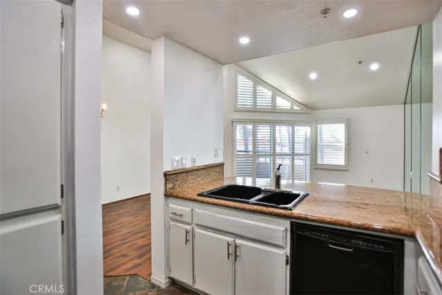 a kitchen with granite countertop cabinets and window