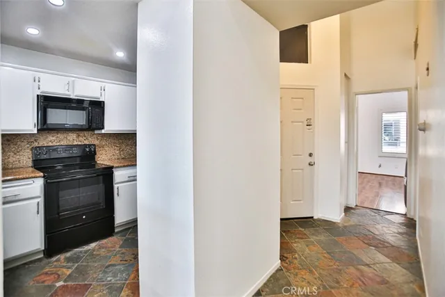 a open kitchen with a sink and a stove top oven