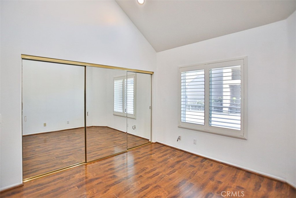 1200 Pacific Coast Highway, Unit 423 Huntington Beach, CA 92648 - Photo 4 of 40 an empty room with wooden floor and windows