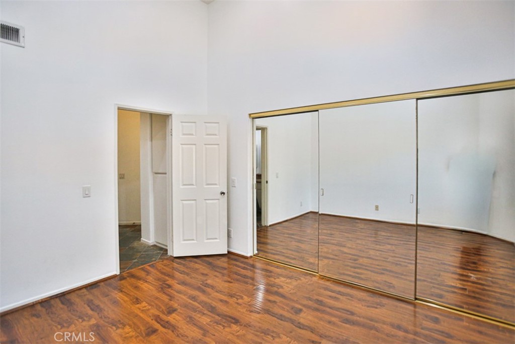 1200 Pacific Coast Highway, Unit 423 Huntington Beach, CA 92648 - Photo 5 of 40 a view of an empty room with wooden floor and closet