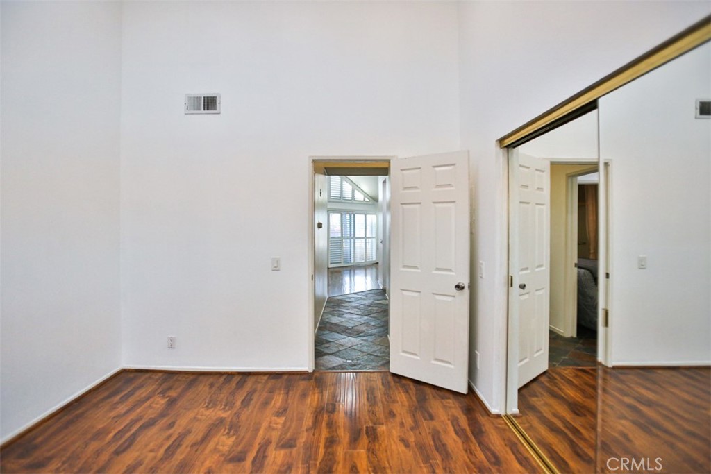 1200 Pacific Coast Highway, Unit 423 Huntington Beach, CA 92648 - Photo 6 of 40 an empty room with wooden floor and windows