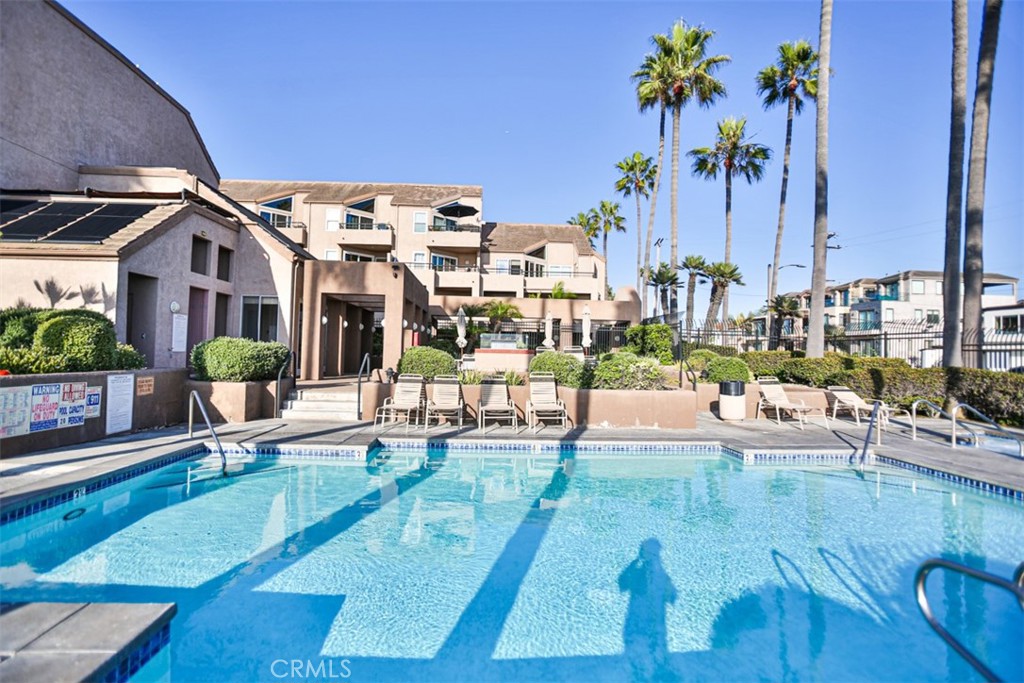 1200 Pacific Coast Highway, Unit 423 Huntington Beach, CA 92648 - Photo 10 of 40 a view of a swimming pool with outdoor seating