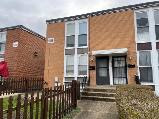 a view of a brick house with large windows