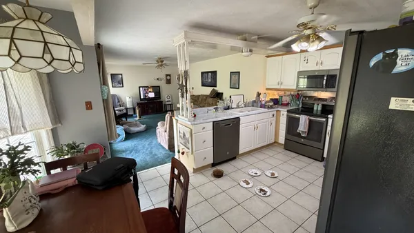 a kitchen with stainless steel appliances granite countertop a stove refrigerator and a sink