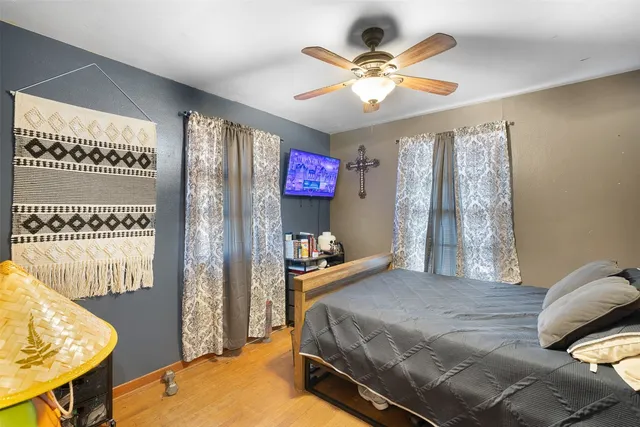 a bedroom with a bed and a chandelier