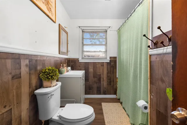 a bathroom with a toilet a sink and a window