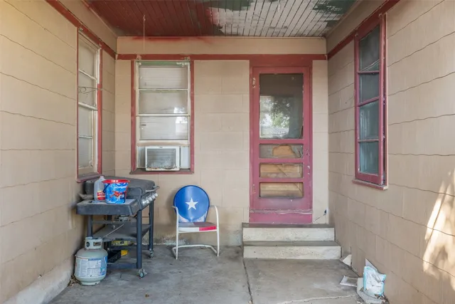 a backyard of a house with barbeque oven and wooden fence