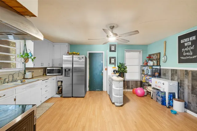 a kitchen with a sink a refrigerator and a stove