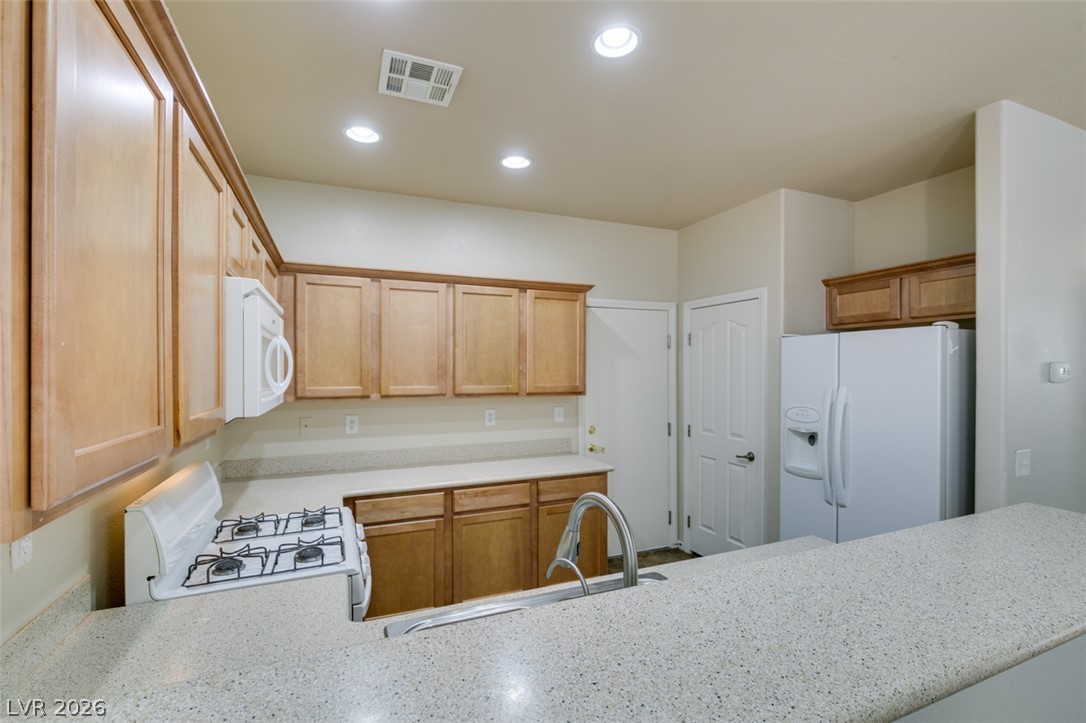 8937 Caledon Ridge Court Las Vegas, NV 89149 - Photo 20 of 43 Culinary delights await in this modern kitchen with ample cabinetry and sparkling countertops.