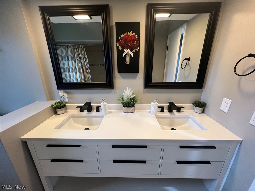 7475 Selwick Drive Parma, OH 44129 - Photo 20 of 29 Bathroom with vanity with extensive cabinet space and dual sinks