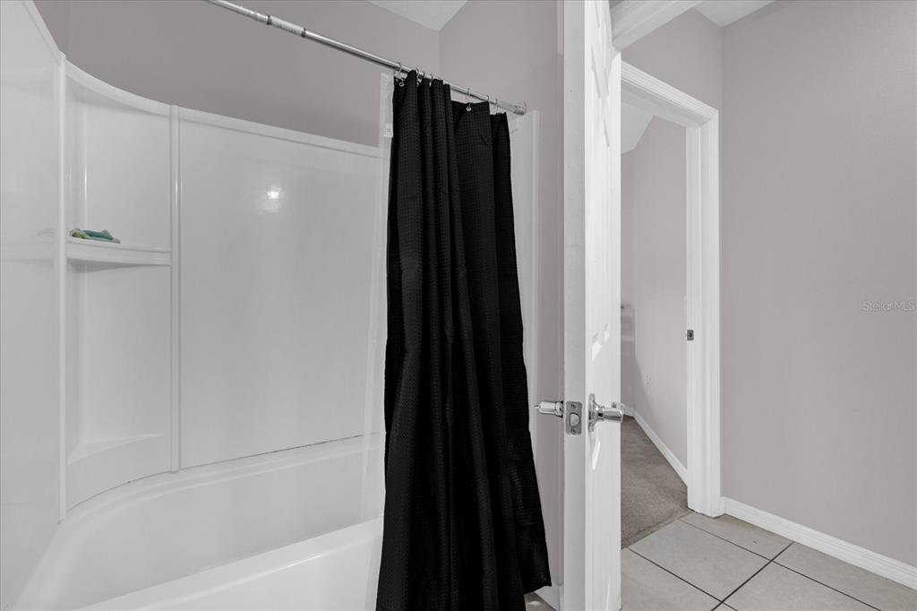 3470 Beau Road Kissimmee, FL 34746 - Photo 22 of 40 a bathroom with a shower and a tub