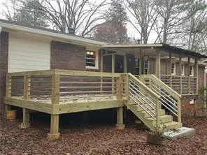 a view of a house with a yard and deck
