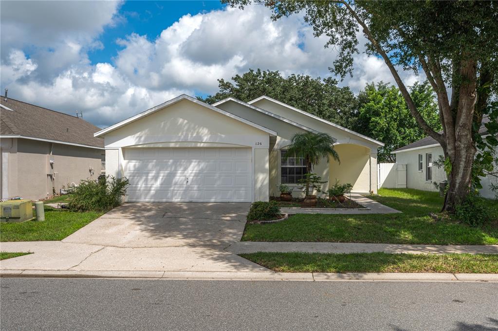 126 Piano Lane Davenport, FL 33896 - Photo 1 of 24 a front view of a house with garden