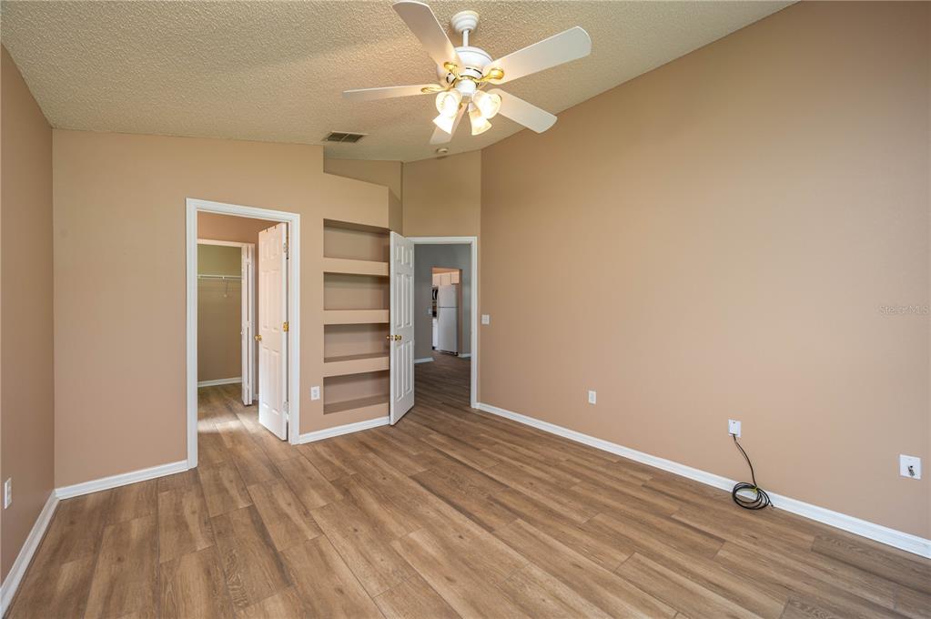 126 Piano Lane Davenport, FL 33896 - Photo 11 of 24 wooden floor in an empty room with a window