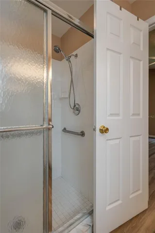 a bathroom with a glass shower door