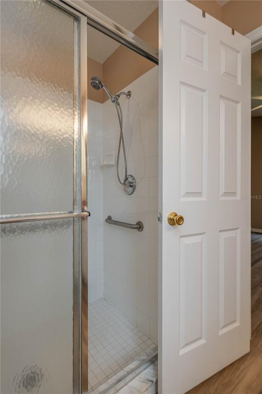 126 Piano Lane Davenport, FL 33896 - Photo 13 of 24 a bathroom with a glass shower door