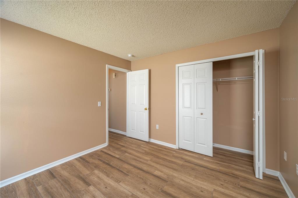 126 Piano Lane Davenport, FL 33896 - Photo 15 of 24 a view of an empty room with wooden floor & closet
