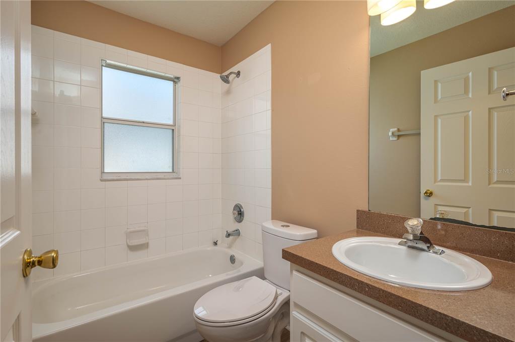 126 Piano Lane Davenport, FL 33896 - Photo 16 of 24 a bathroom with a sink a toilet and shower