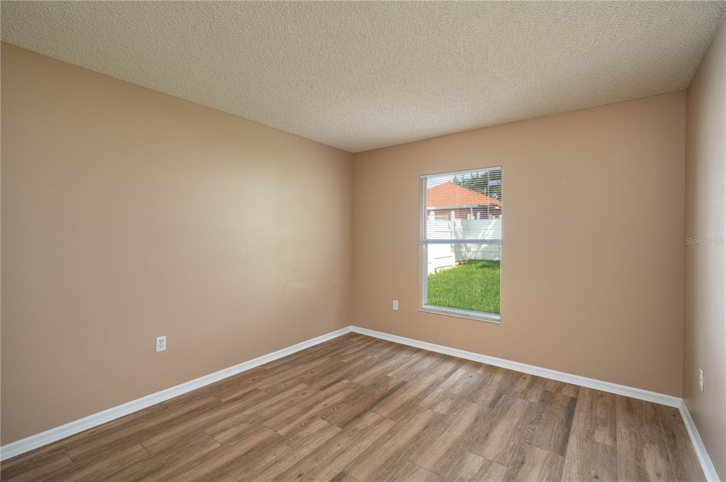 126 Piano Lane Davenport, FL 33896 - Photo 17 of 24 wooden floor in an empty room with a window