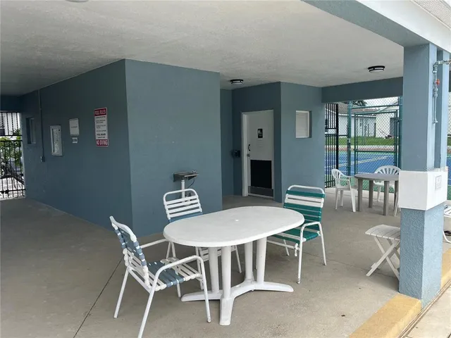 a view of swimming pool with outdoor seating and barbeque oven