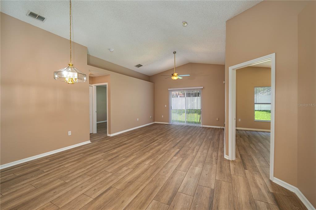 126 Piano Lane Davenport, FL 33896 - Photo 5 of 24 wooden floor in an empty room with a window