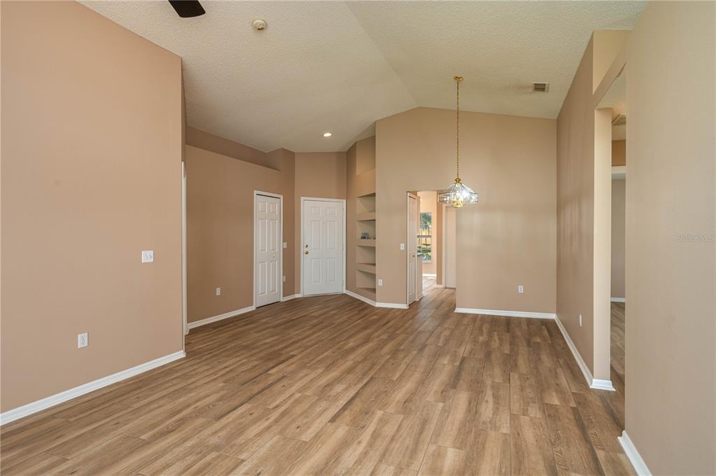 126 Piano Lane Davenport, FL 33896 - Photo 6 of 24 a view of a room with wooden floor and a ceiling fan