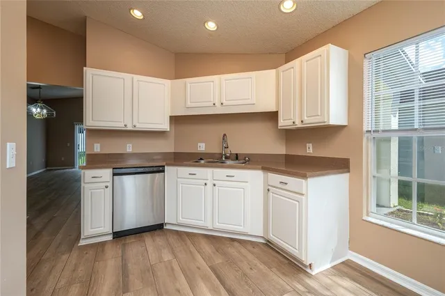 a kitchen with granite countertop white cabinets and white appliances