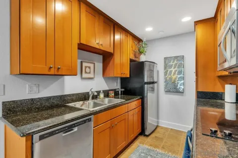 a kitchen with stainless steel appliances granite countertop a sink stove and refrigerator