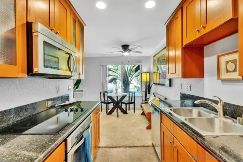 a kitchen with stainless steel appliances granite countertop a sink and a cabinets