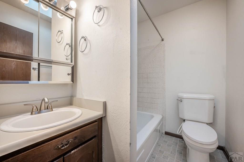 1901 Mohawk Road Pueblo, CO 81001 - Photo 13 of 30 a bathroom with a granite countertop sink toilet and shower