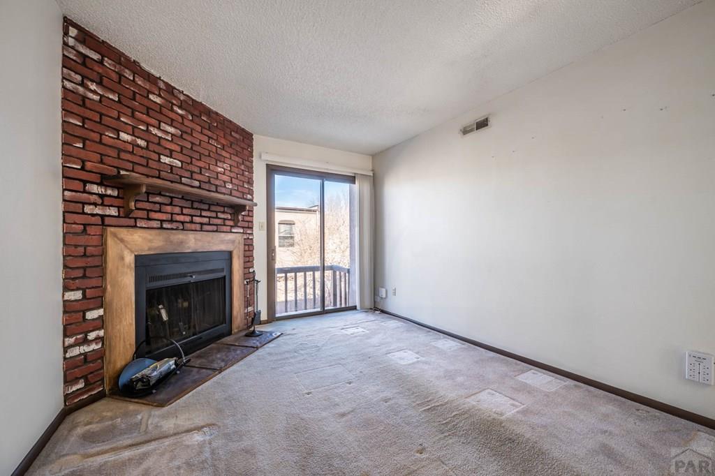 1901 Mohawk Road Pueblo, CO 81001 - Photo 4 of 30 a view of an empty room with a fireplace