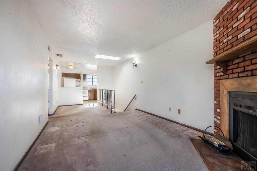 1901 Mohawk Road Pueblo, CO 81001 - Photo 7 of 30 a view of a kitchen with a sink and a fireplace