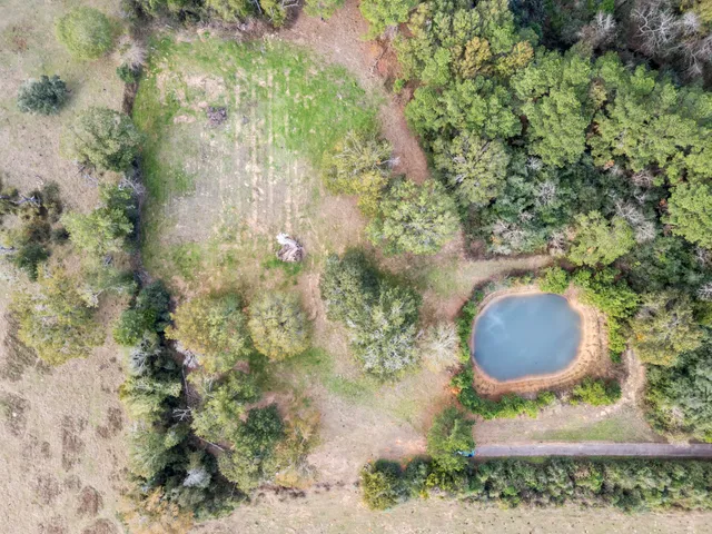 an aerial view of a golf course with parking space