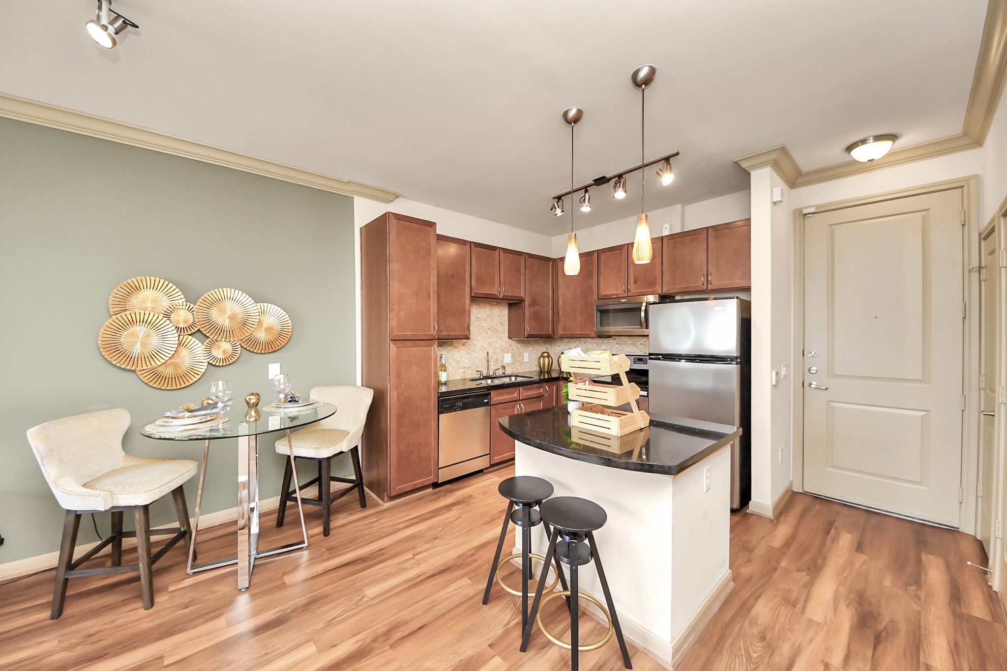 6363 San Felipe Street, Unit 235 Houston, TX 77057 - Photo 6 of 43 a kitchen with stainless steel appliances granite countertop a stove a refrigerator a dining table and chairs with wooden floor