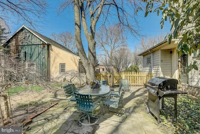 a view of a chairs and table in backyard of the house