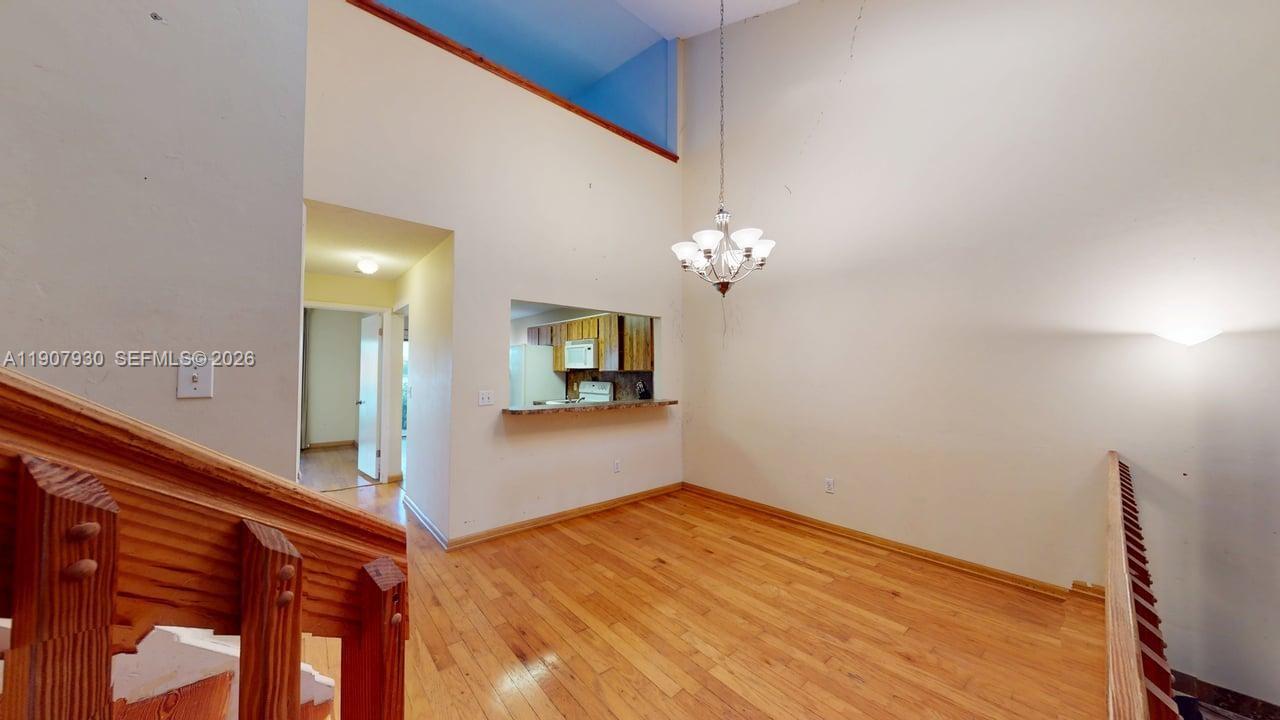 4222 Southwest 87th Terrace Davie, FL 33328 - Photo 19 of 85 a view of a hallway with a chandelier