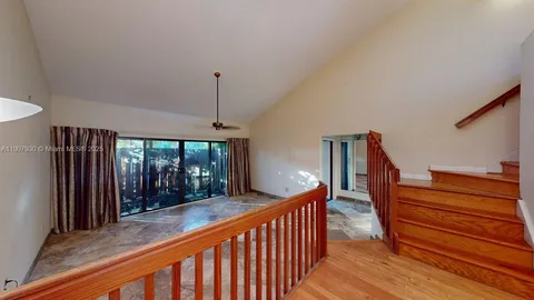 a view of living room with a granite countertop couches with wooden floor