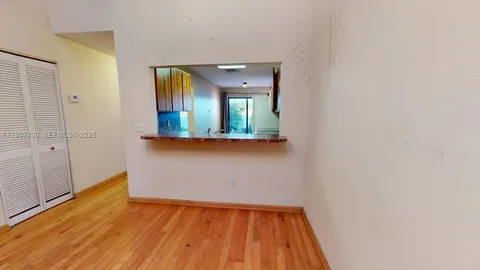 a view of living room with a granite countertop couches with wooden floor