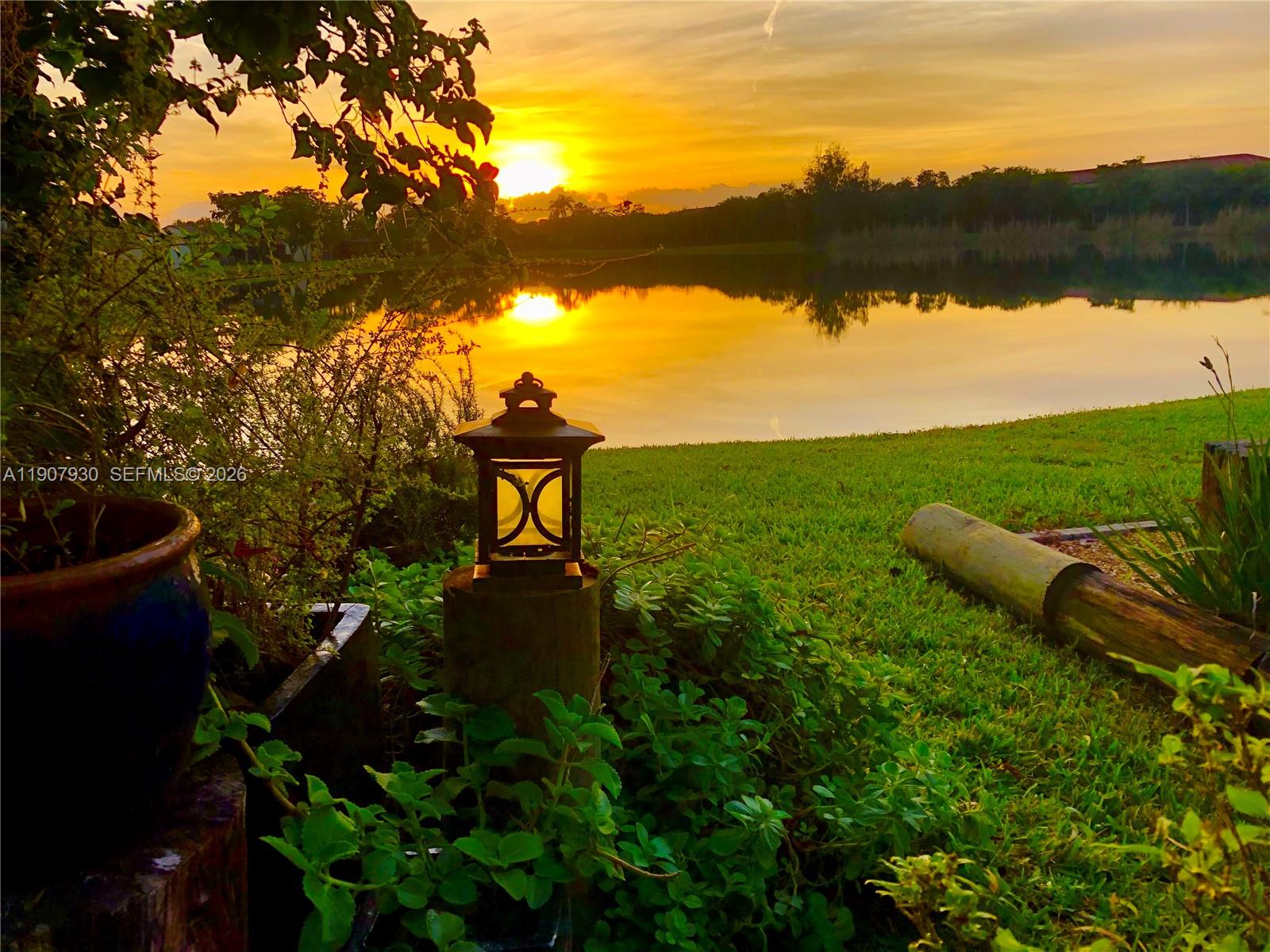 4222 Southwest 87th Terrace Davie, FL 33328 - Photo 3 of 85 Serene backyard retreat framed by lush greenery and calm waters perfect for morning coffee or weekend relaxation