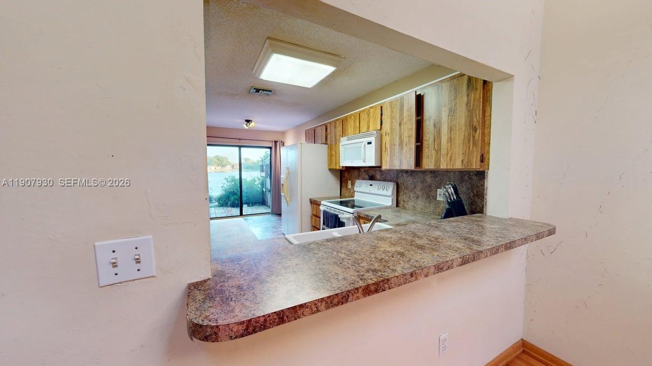 4222 Southwest 87th Terrace Davie, FL 33328 - Photo 32 of 85 a view of living room with a granite countertop couches with wooden floor