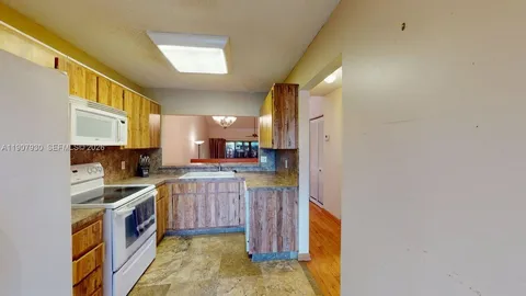 a view of an empty room and a window