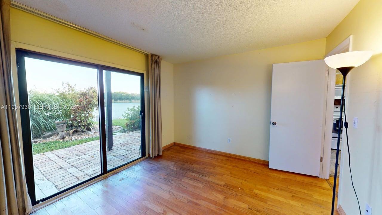 4222 Southwest 87th Terrace Davie, FL 33328 - Photo 46 of 85 a view of an empty room with wooden floor and a window