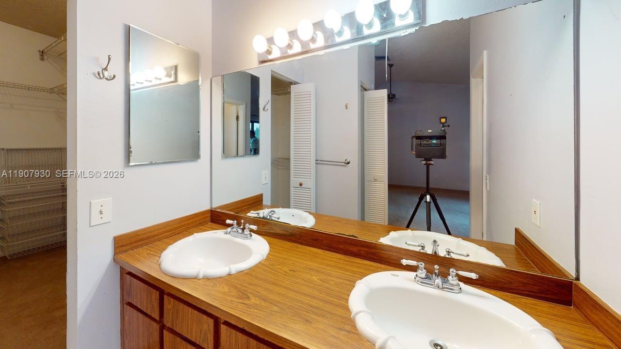 4222 Southwest 87th Terrace Davie, FL 33328 - Photo 68 of 85 a bathroom with a sink and a mirror