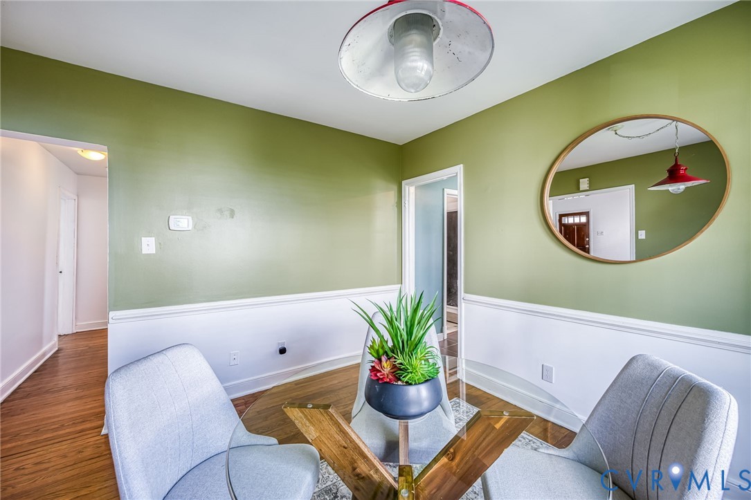 2129 Ginter Street Richmond, VA 23228 - Photo 11 of 38 a living room with a mirror and a potted plant