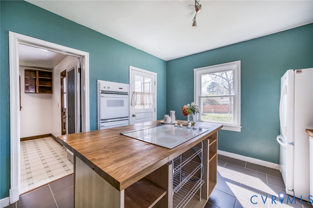 2129 Ginter Street Richmond, VA 23228 - Photo 15 of 38 a kitchen with stainless steel appliances granite countertop a sink stove and refrigerator