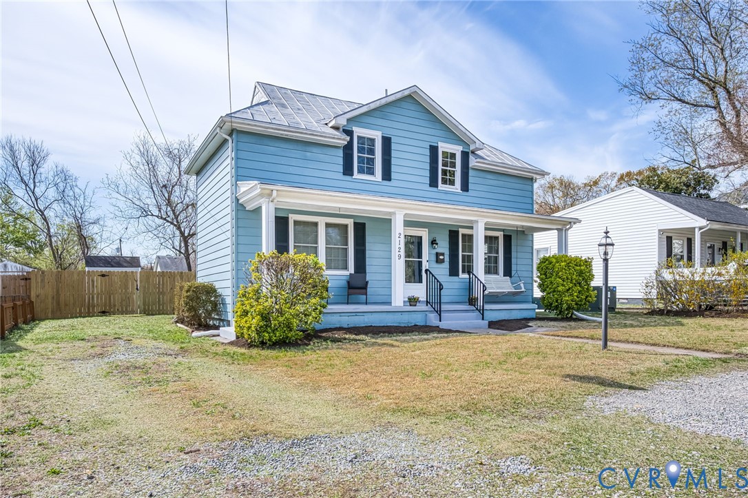 2129 Ginter Street Richmond, VA 23228 - Photo 2 of 38 a front view of a house with a yard and outdoor seating