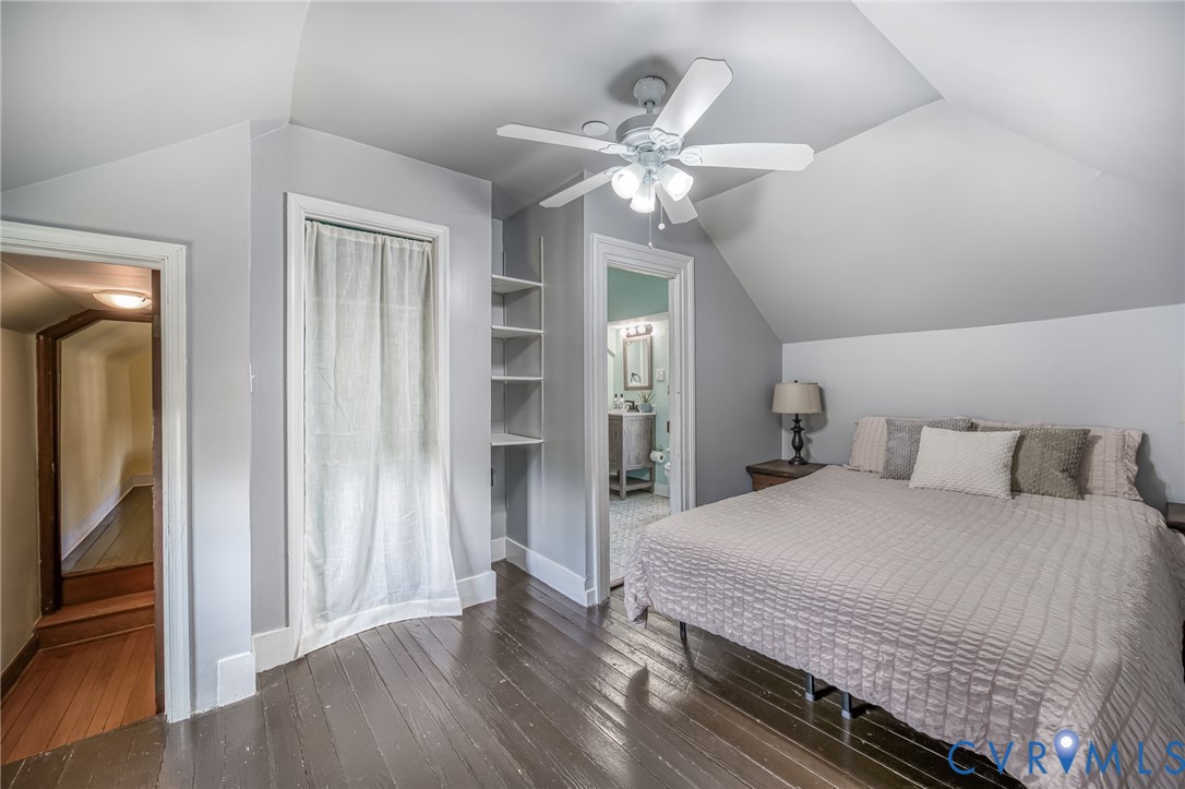 2129 Ginter Street Richmond, VA 23228 - Photo 21 of 38 a bedroom with a large bed and a chandelier