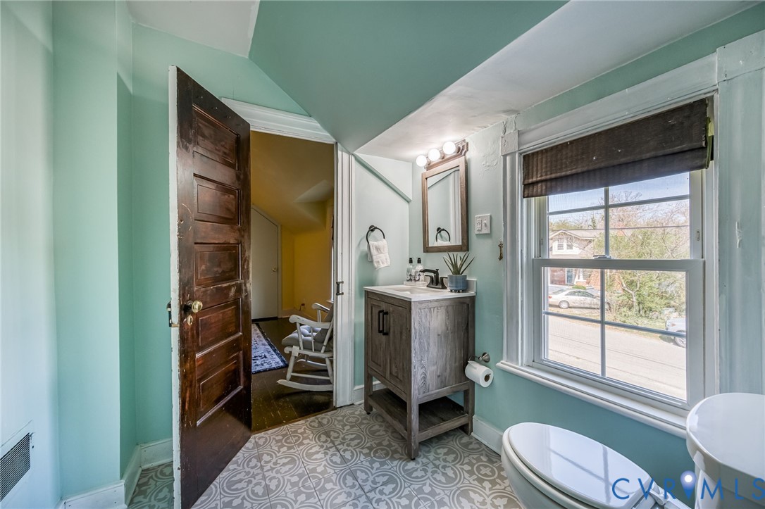 2129 Ginter Street Richmond, VA 23228 - Photo 23 of 38 a bathroom with a toilet sink and mirror