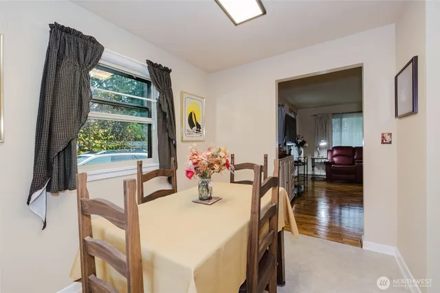 a kitchen with a refrigerator and a dining table