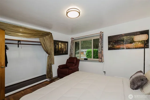 a bedroom with a bed and a painting on the wall